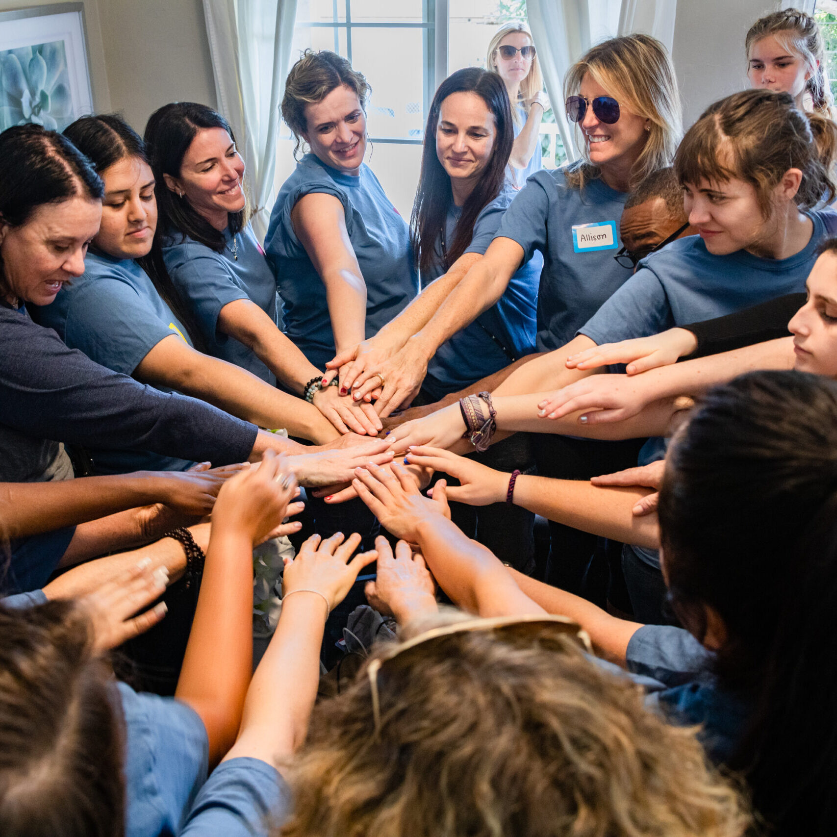 SAM Initiative members with hands in a circle